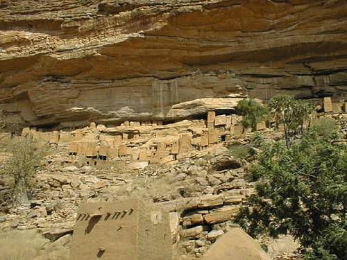 Cliffside dwellings above the village of Teli which have been virtually abandoned for the more prosaic settlements down in the flats. Pictured are not only the homes of the Tellem people, but also the granaries which are still being used to store millet and other supplies as well as the burial caves which are located in the cliff high above all homes.